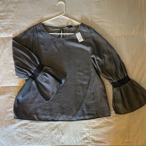Grey denim top with black detailed sleeve. Brand new